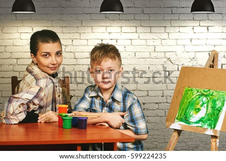 the little boy, the artist paints a picture . Preschool education