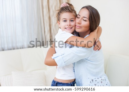 Beautiful Delighted Mother and Daughter in a light spacious room. Happy family mom and daughter Together Rejoice and Embrace each other     