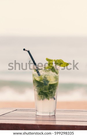 Mojito cocktail with ice on the beach backgroun