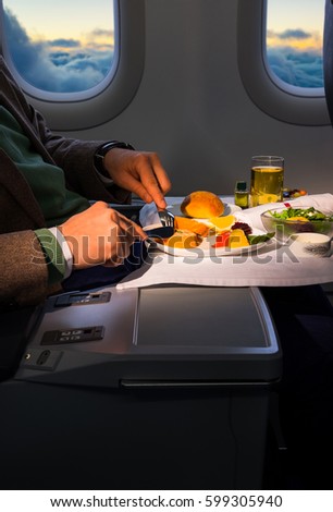 Food served on board of business class airplane on the table.