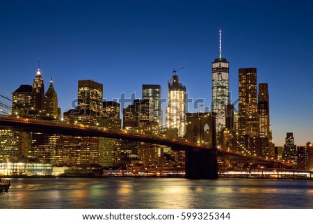 Brooklyn Bridge and New York City Manhattan skyline at dusk