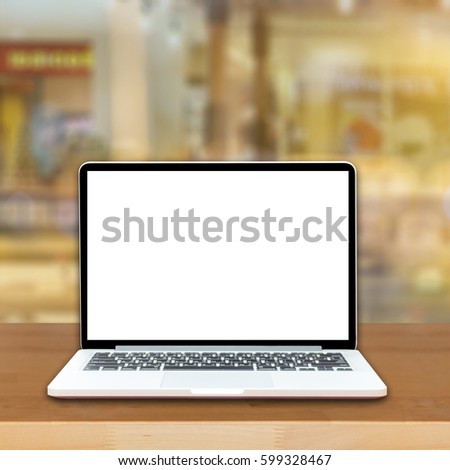 Open laptop computer  lying on a wooden table in cafe bar interior, portable net-book with copy space screen for your information content or text message, freelance , internet,vintage color

