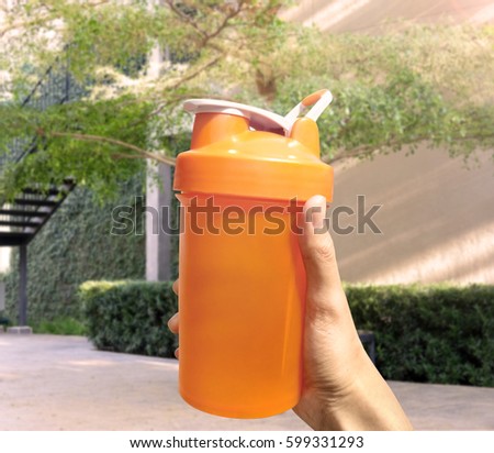 hand holding a plastic bottle