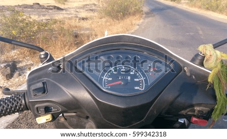 speedometer of scooter with road 