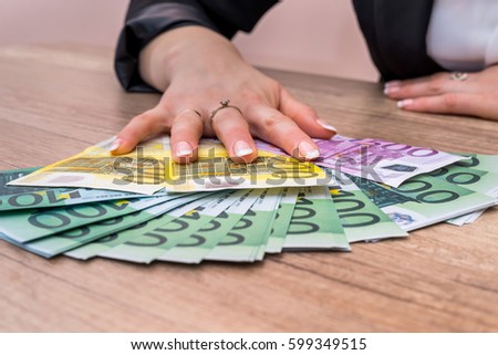 Woman holding 100 200 500 euro bills. money concept.