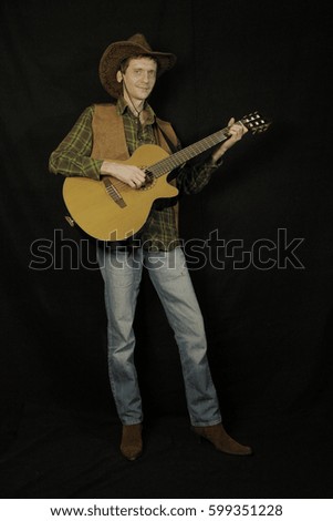 cowboy with guitar on black background
