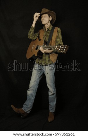 cowboy with guitar on black background