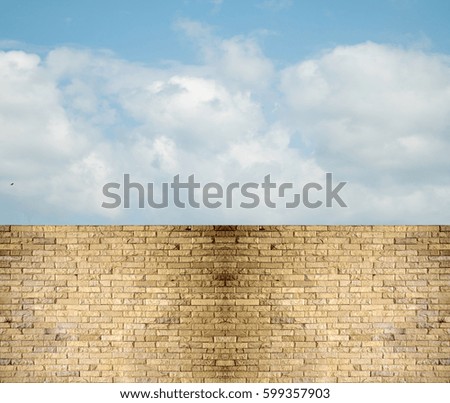 sky clouds over stone fence