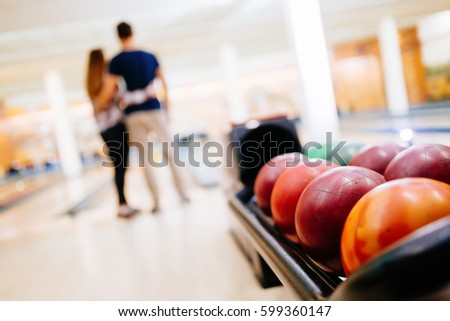 Couple enjoy bowling together  and hugging