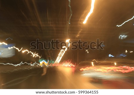 light motion with slow speed shutter,Street lights in speeding car in night time.
