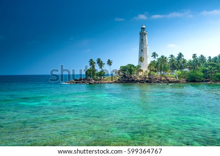 Beautiful beach and lighthouse in SriLanka Royalty-Free Stock Photo #599364767