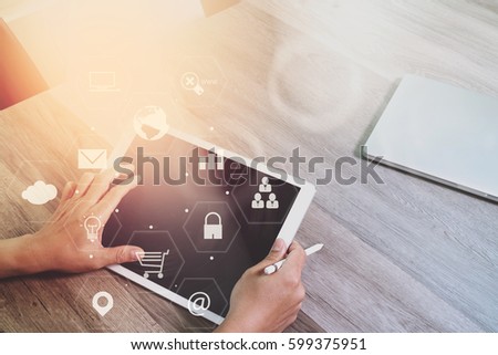 businessman working with smart phone and laptop computer on wooden desk in modern office with virtual icons interface