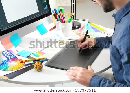 Modern designer working with graphic tablet