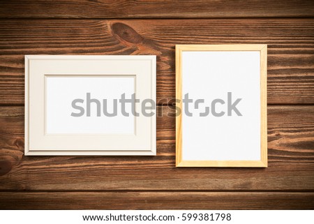 Picture frame on a wooden wall.