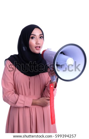 Portrait of a gorgeous Muslim young woman holding megaphone. Warning sign