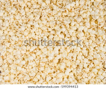 Scattered salted popcorn, texture background.  Royalty-Free Stock Photo #599394413