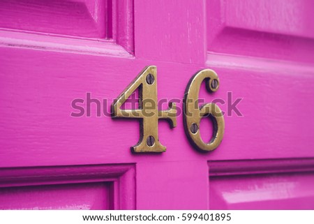 House number 46 on a pink wooden door.