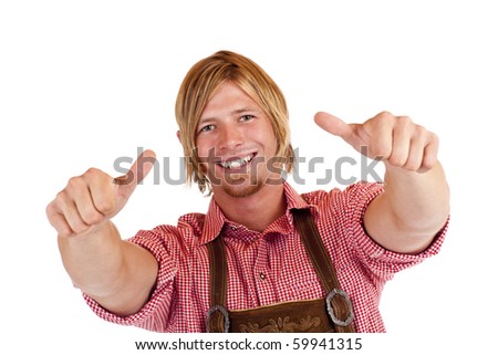 Bavarian man with oktoberfest leather trousers (Lederhose) shows both thumbs up.  Isolated on white background.