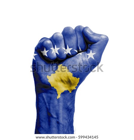Kosovo national flag painted onto a male clenched fist. Strength, Power, Protest concept