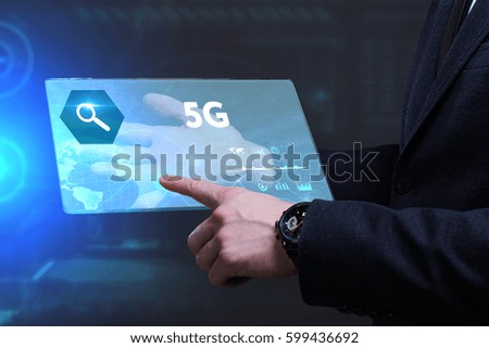 Business, Technology, Internet and network concept. Young businessman working on a virtual screen of the future and sees the inscription: 5G
