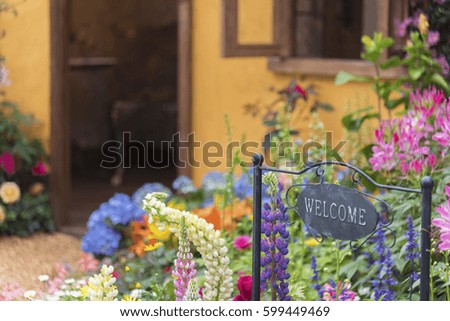 Welcome home sign in backyard garden of residential house