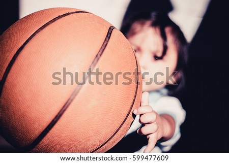 Kid playing basketball.
