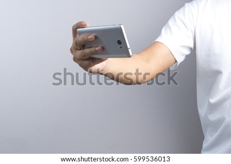 Hand taking a photo or video by mobile phone on white background
