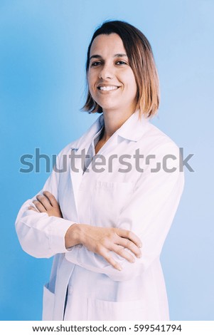 Smiling beautiful doctor at hospital. Standing. Looking at camera.