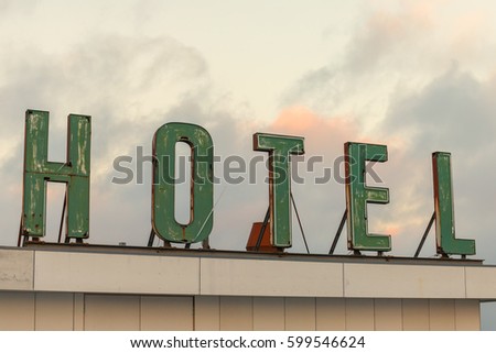 Old neon sign on top of abandoned Hotel.