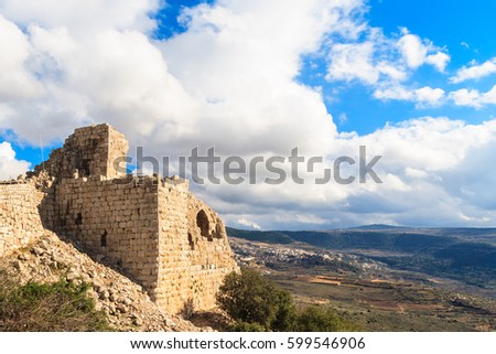 Ruins of ancient Crusader fortress, Golan Heights background, beautiful sky with white clouds, Upper Galilee, Israel. Concept: travel, history and nature