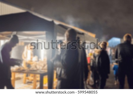 Blur image of people standing, outdoor party celebration at night.