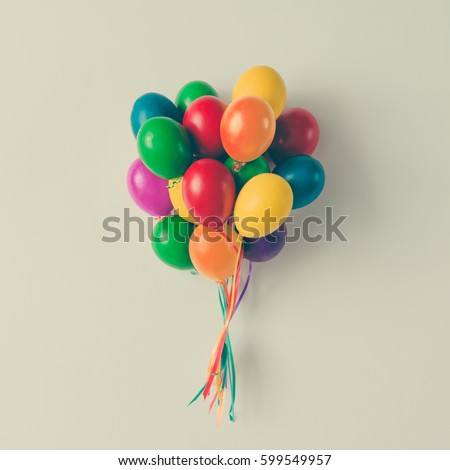 Colorful bunch of Easter egg balloons on bright white background. Minimal creative concept. Flat lay.
