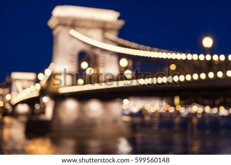 Chain bridge (Szechenyi lanchid) in Budapest with bokeh of city lights, blurred defocused background for your project Royalty-Free Stock Photo #599560148