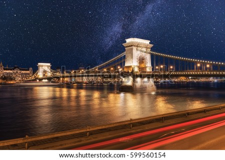 Beautiful night Budapest, the Chain bridge (Szechenyi lanchid) across the Danube river in lights and starry sky, cityscape suitable for cover or desktop background