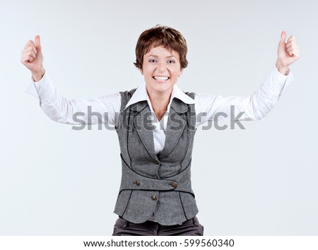 Expressive businesswoman. Half-length emotional portrait of caucasian young woman. Victory screaming. Funny winner adult shouting with hands up.