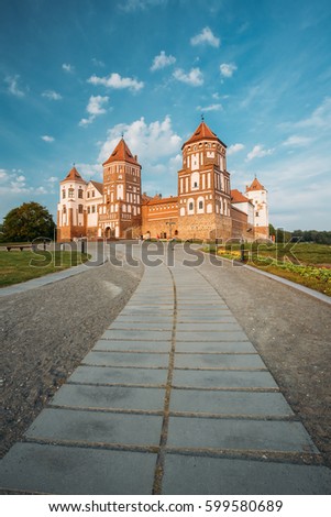 Mir, Belarus. Pathway To Mir Castle Complex On Blue Sunny Sunset Sky Background. Architectural Ensemble Of Feudalism, Cultural Monument, UNESCO Heritage. Famous Landmark In Summer