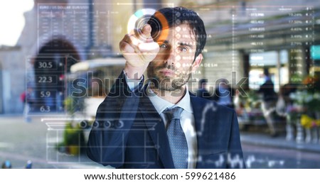 A businessman in a suit uses holography and augmented reality to see in 3D graphics financial economics. Concept: immersive technology, business, economy, futuristic lessons and future.