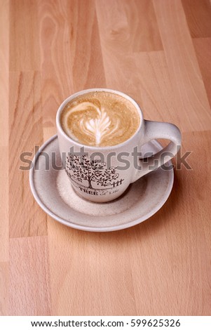 Coffee beverage on wooden background. Cup of cappuccino.