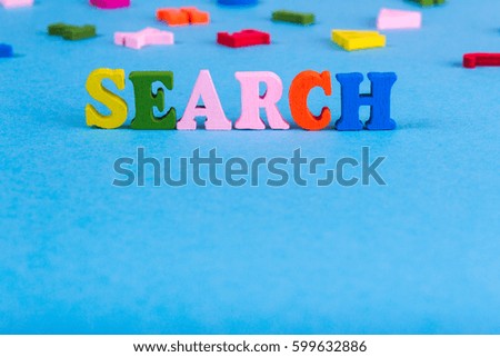 Word search made of colored wooden letters on a blue background
