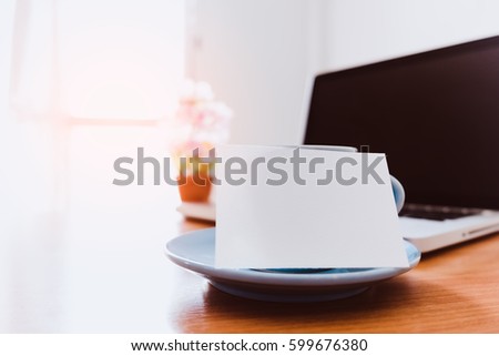 White business card with coffee cup.
