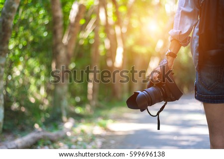Travel woman hand holding camera

