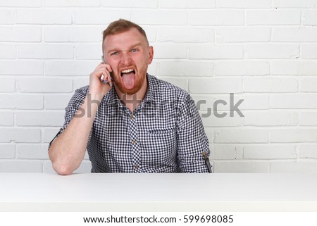 A hipster businessman is talking on the phone. He is very emotional. On a white background. Isolated.