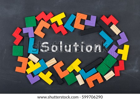Business Solution concept - inscription and jigsaw blocks on the blackboard