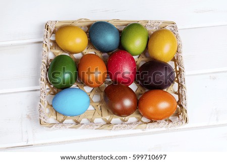 Easter eggs in the basket  on  wooden background