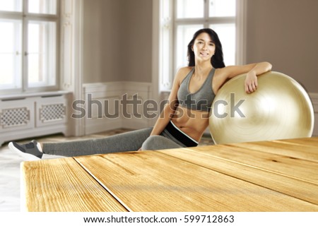 Wooden desk of free space for your decoration and woman on floor 
