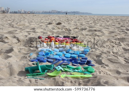 Plastic pieces, found at the beach are arranged by colour. 