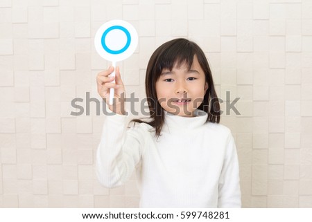 Asian girl with a Yes sign