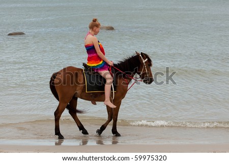 Horse riding on the beach Royalty-Free Stock Photo #59975320