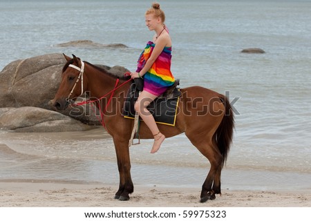 Horse riding on the beach Royalty-Free Stock Photo #59975323
