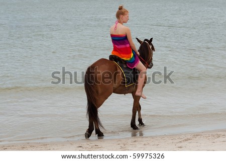 Horse riding on the beach Royalty-Free Stock Photo #59975326